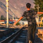 Balance. - Teenage Boy Walking on Railway Tracks
