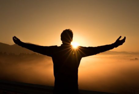Success - silhouette photo of man on cliff during sunset