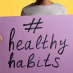 Healthy Habits - Person Standing and Holding a Poster