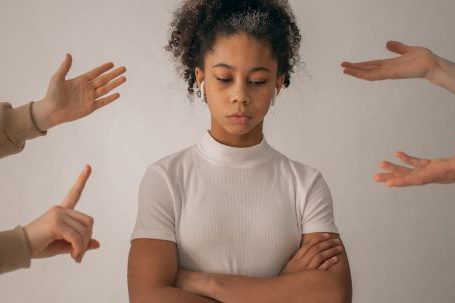 Vulnerable Authenticity - Faceless people scolding discontent black girl