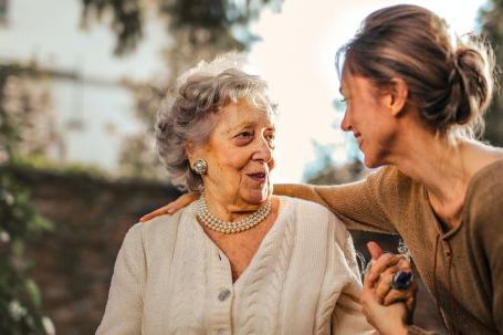 Values-happiness Relationship - Joyful adult daughter greeting happy surprised senior mother in garden