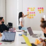 Communication - woman placing sticky notes on wall