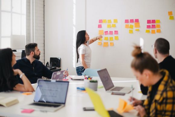 Communication - woman placing sticky notes on wall