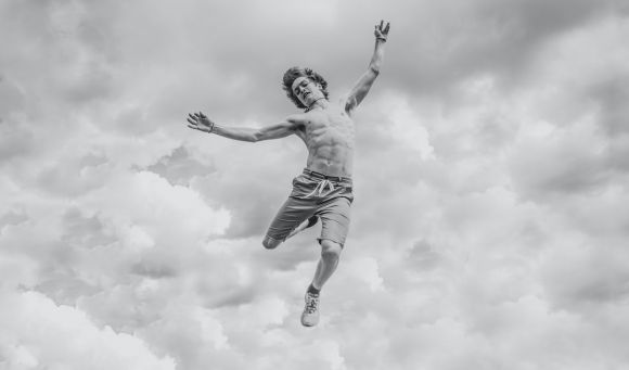 Taking Action. - grayscale photo of person jumping overlooking clouds