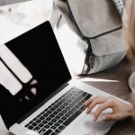 Self-empowerment, Self-compassion - Close-up Photography of Woman Sitting Beside Table While Using Macbook