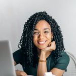 Positive Transformations - Happy ethnic woman sitting at table with laptop